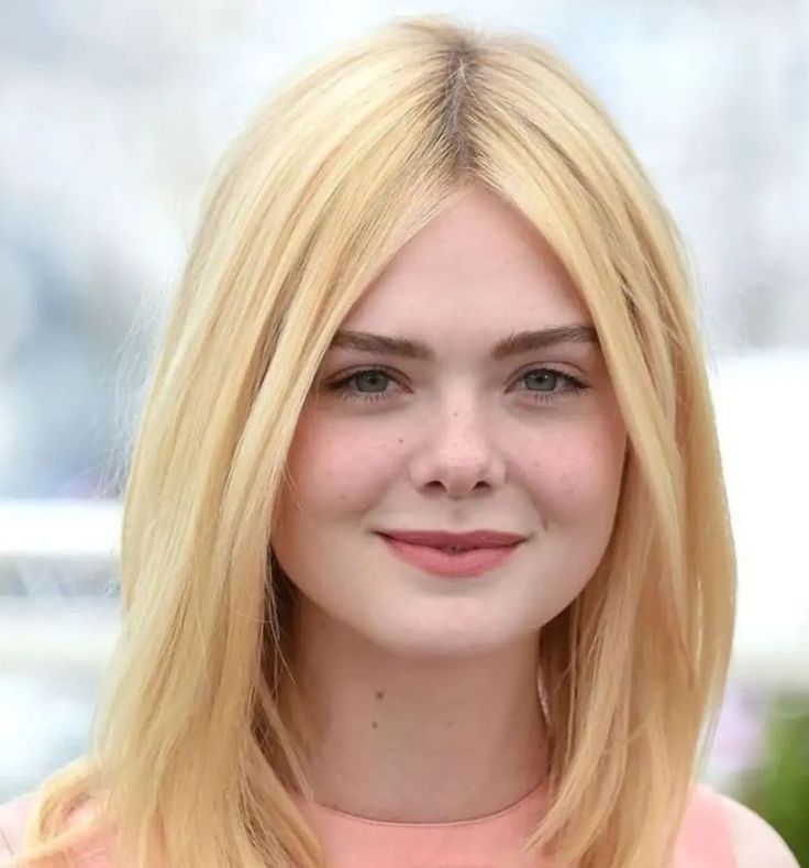 10 Fascinating Facts About Elle Fanning: From Child Star to Hollywood Icon Elle Fanning posing on the red carpet in a designer gown, showcasing her ethereal Hollywood style