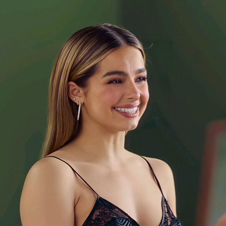 Addison Rae smiling at a fashion event, representing her TikTok and entertainment empire
