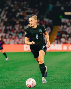 Georgia Stanway celebrating after scoring a powerful long-range goal for England during an international match