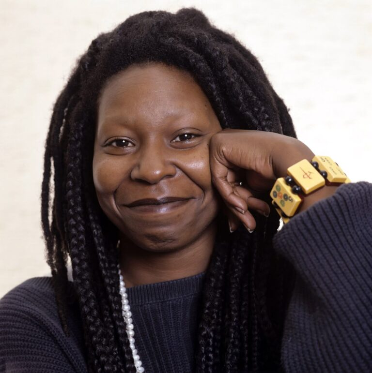 “Whoopi Goldberg smiling on red carpet at Hollywood awards ceremony”