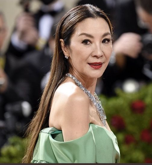 "Lucy Liu performing a martial arts stunt on film set, Oscar-winning Hollywood actress and Asian cinema icon"