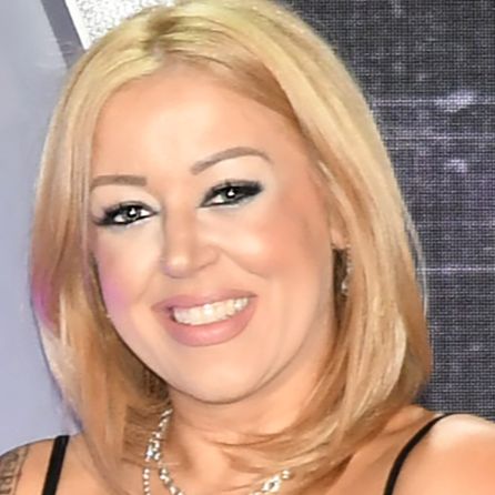 Lynsi Snyder, president of In-N-Out Burger, standing confidently representing the billionaire family-owned fast-food empire in California.