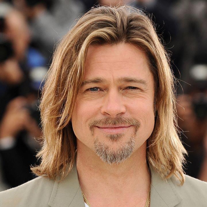 "Brad Pitt at movie premiere, wearing suit, iconic Hollywood star"