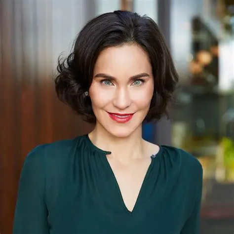 Laura Arnold speaking at a philanthropy conference, representing evidence-based giving and modern billionaire philanthropy